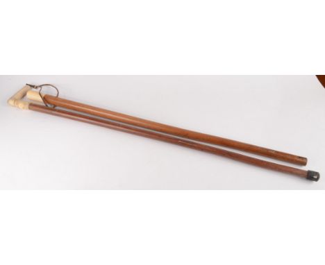 An ivory handled and malacca walking stick, 19th century, carved with a cartouche mounted by a rope and tassels, length 88cm 
