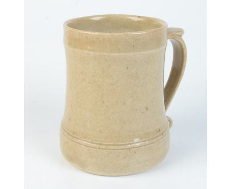 A Leach pottery cream glazed mug, impressed mark to base, height 11.8cm. 