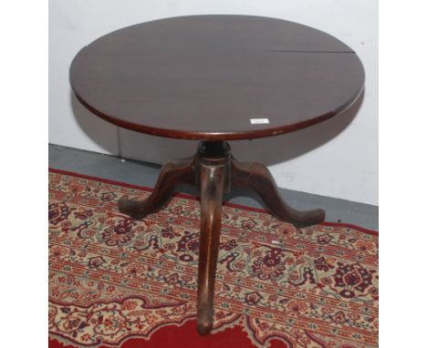 A George III mahogany tripod table, the circular top on a baluster turned stem on cabriole supports on pad feet, height 56cm,