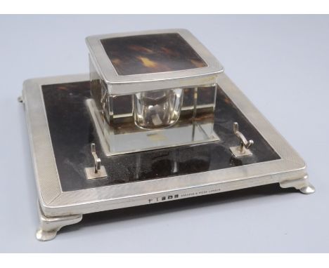 A silver and tortoiseshell inkstand by Mappin & Webb London, 1929, engine turned on bracket feet, height 6.5cm, 14.5cm square