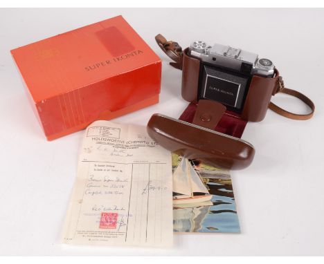 A Zeiss Ikon Super Ikonta camera, in a brown leather case, with original box, sales receipt 1956 and associated paperwork.