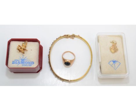 A 15ct gold late Victorian bangle 5g and a 9ct gold signet ring, together with two gold charms. 