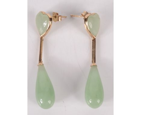 A pair of jade gold mounted earrings, each of heart form with a pendant drop. Condition report: 43 mm long, good condition.  