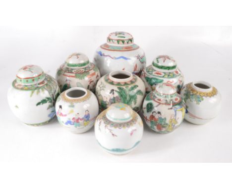 Nine Chinese ginger jars, five with covers, the largest jar decorated with warriors on horseback, red four character Kangxi m