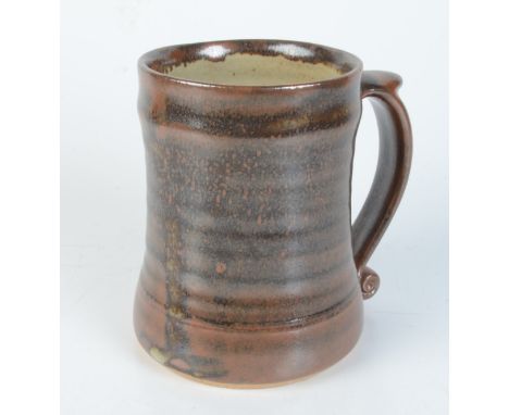 A Leach pottery brown glazed mug, impressed mark to base, height 12.2cm. 