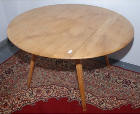 A set of five Ercol dining chairs, including an armchair and a matching drop leaf table, the chairs bearing original silver s