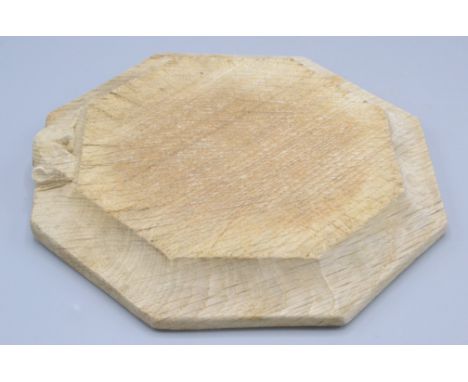A Robert 'Mouseman' Thompson of Kilburn octagonal oak chopping board, with carved mouse signature, 18.5 x 19cm.