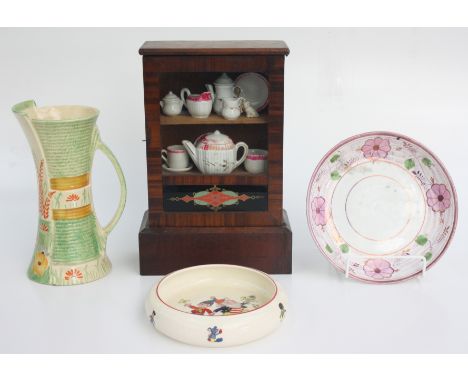 A Wadeheath jug, height 22cm, a Noddy Ware bowl, entitled 'Happy Days', diameter 17cm a Sunderland lustre dish, diameter 19.5