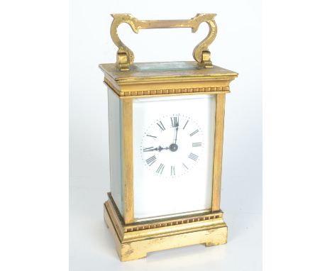 A brass carriage clock,, inscribed 'E.P. Hall from the staff Granada 1936', height of case 12.3cm, width 7.6cm.