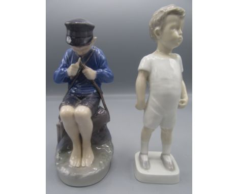 A Royal Copenhagen porcelain figure of a seated boy whittling a stick, height 18cm, a Royal Copenhagen dish, diameter 16.7cm 