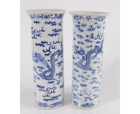 Two Chinese porcelain blue and white cylindrical vases, late 19th century, decorated with dragons chasing the flaming pearl a