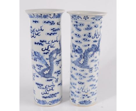 Two Chinese porcelain blue and white cylindrical vases, late 19th century, decorated with dragons chasing the flaming pearl a