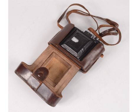 A Zeiss Ikon camera, in brown leather case.