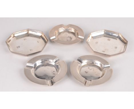 A set of three engine turned post-war silver ashtrays and a pair of post-war Britannia standard octagonal small dishes, 8oz.