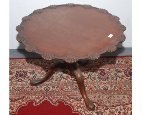 A Georgian mahogany tripod table, the shell carved top on a fluted stem with leaf carved cabriole supports with pad feet, hei