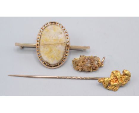 A gold nugget stick pin, 4.5g, a 9ct gold mounted pendant set with a gold quartz specimen and gold quartz set brooch.