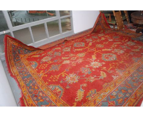 A Ushak carpet, the madder field with an all over design of palmettes, serrated leaves and flowering vines and stylised plant