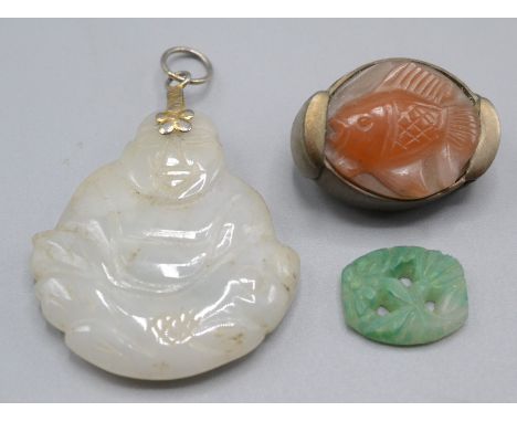 A Chinese jade Buddha carved pendant and two other pieces.