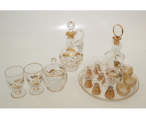 Two glass gilt decorated decanter sets. Condition report: Small chip to stopper of second largest decanter. Two chips to base