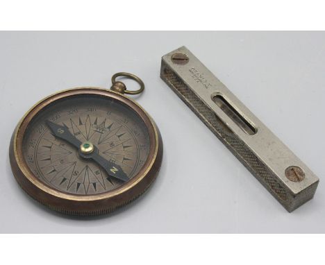 A metal cased compass by T. Harris & Sons, London, diameter 7cm and a spirit level inscribed Stanley, New Britain, Conn, USA,