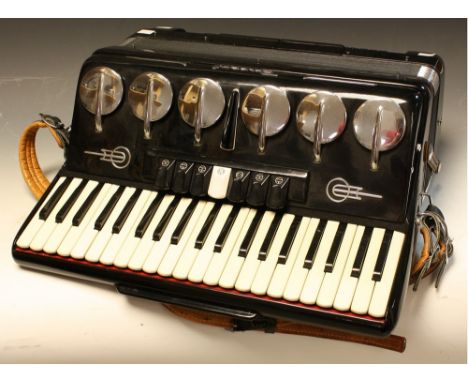 A Parrot piano accordion, with full size treble keyboard and bass buttons, volume enhancing vents and tabs above and slide be