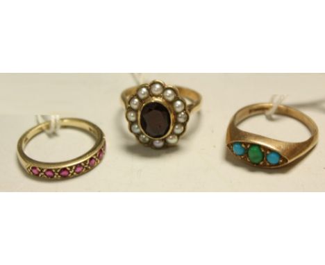 A 9ct gold turquoise dress ring, 3.9g; a 9ct gold ruby half eternity ring, 2.1g; a 9ct gold garnet and seed pearl cluster rin