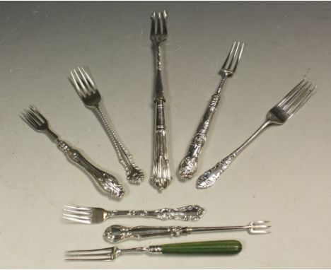 A George V silver pickle fork, acanthus capped scroll terminal, Birmingham 1911; other silver and silver plated pickle forks 