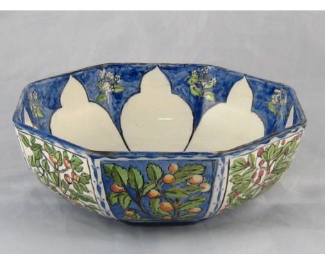 A Wedgwood Arts and Crafts ceramic octagonal nut bowl, the panels painted with nuts and berries, the inside with Moorish arch