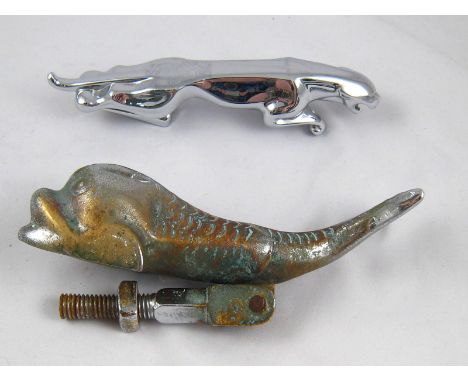 A chromium plated Jaguar car mascot, 19cm. long, together with a vintage brass dolphin door knocker, later plated,20cm. long.