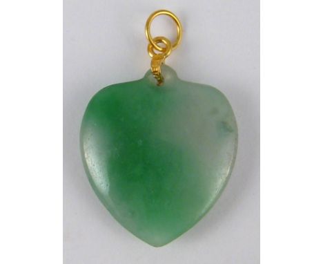 A jade heart pendant with a yellow metal (tests 14 carat gold) fitting, heart approx 23mm wide, 5.6 gms.
