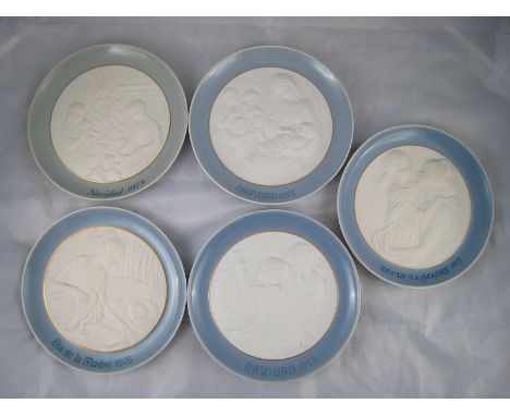A set of three Lladro Christmas plates, 1973,75,77, and two Mother's day plates 1975,76., all 20cm. diameter. 