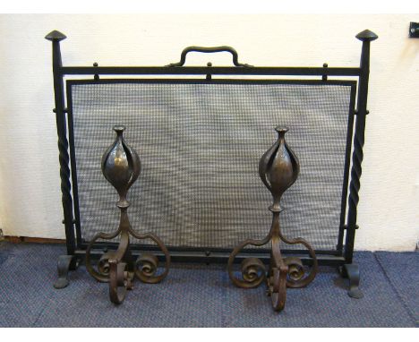 A pair of heavy wrought iron Arts & Crafts firedogs and firescreen. Firedogs ht. 40cm., screen 76x 61cm. high. 