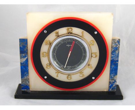 A 1930s classic Art Deco keywind Le Coultre mantel clock in contrasting colour stone, metal and plastic materials, the black 