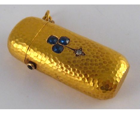 An antique 18 carat gold sapphire and diamond hammered effect vesta case, sapphire set button, the principal sapphires of goo