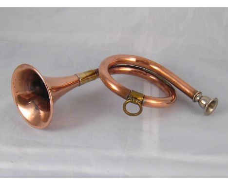 A copper hunting horn with brass mounts and plated mouthpiece. 