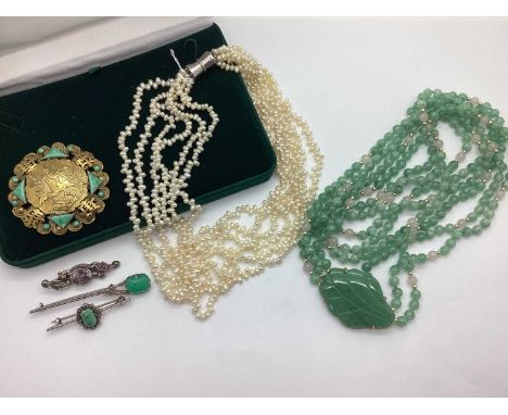 A Jade Colour Three Row Bead Necklace, with leaf panel detail; together with a jade style inset circular panel brooch; a mode