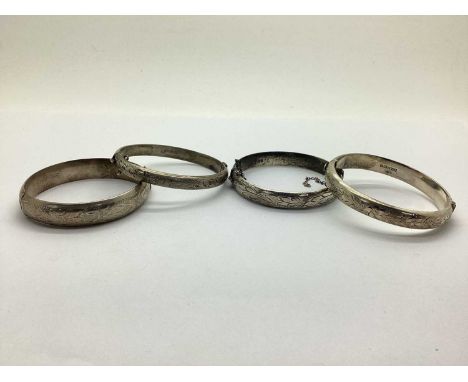 A Hallmarked Silver Hinged Bangle, of etched floral design with safety chain, together with three hallmarked silver bangles o