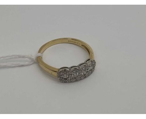 A Modern 18ct Gold Diamond Set Ring, illusion set with graduated brilliant cut stones (finger size R).The ring weighs 3 grams