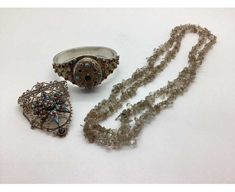 A Decorative Locket Bangle, of shaped design, oval locket to the centre, with collet set and raised highlights, hinged to sna