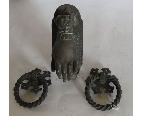 A Victorian design brass door knocker in the form of a hand and a pair of Victorian spirally turned door knockers&nbsp; (3)