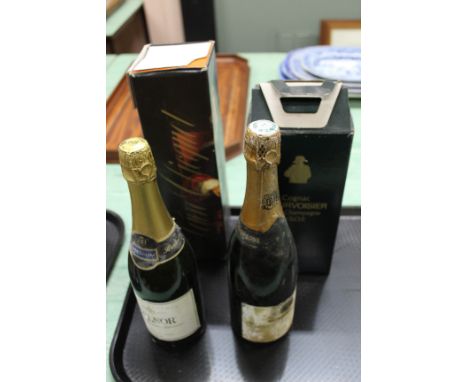 A bottle of Courvoisier fine champagne cognac, Veuve Clicquot plus two other sparkling wines