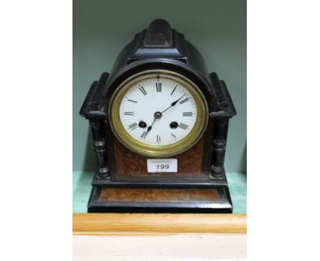 An ebonised and walnut striking mantel clock