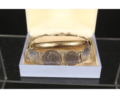 A silver bracelet made up of various Victorian silver coins and 9ct gold metal core bangle