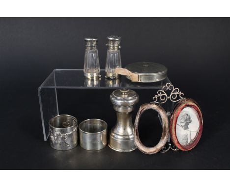 A mixed lot including silver pepper grinder, two silver napkins rings (as found), silver double photo frame (as found), white