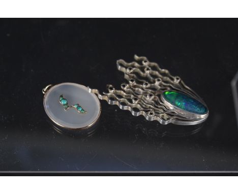 A large abstract silver brooch set with oval opal effect stone and small blue stones, together with a yellow metal framed pen