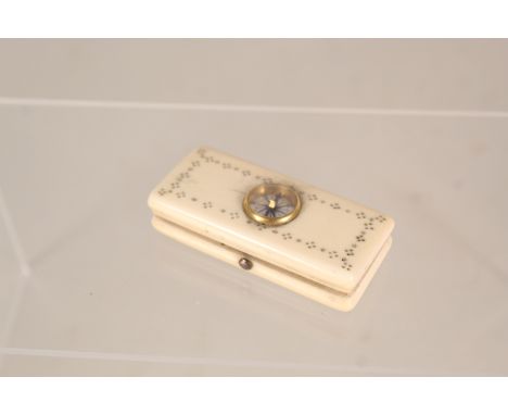 An ivory box containing a thermometer by W Elliott, London, the lid inset with a compass