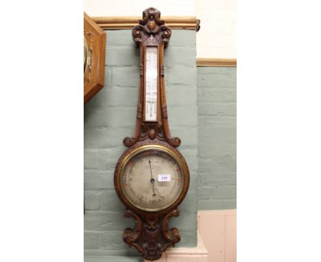 A carved oak aneroid barometer, dial marked Arthurs, Northampton