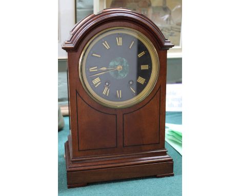 A mahogany striking mantel clock with malachite central dial, marked Enocot