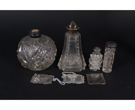 A four cut glass silver and white metal topped scent bottles (all as found), two silver plated decanter labels and a French m