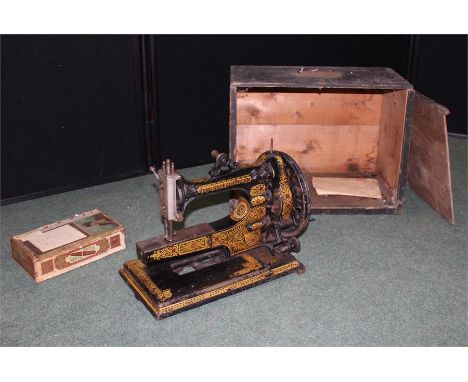 Vintage Sewing machine by E. Ward, London,in wooden box, together with an amount of sewing machine tools